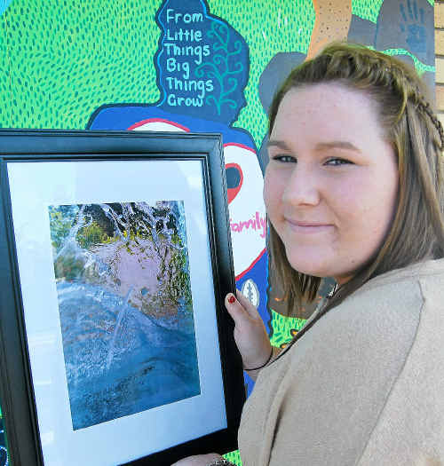 Lauren Page with one of her photographic works, Aqua Impact. 